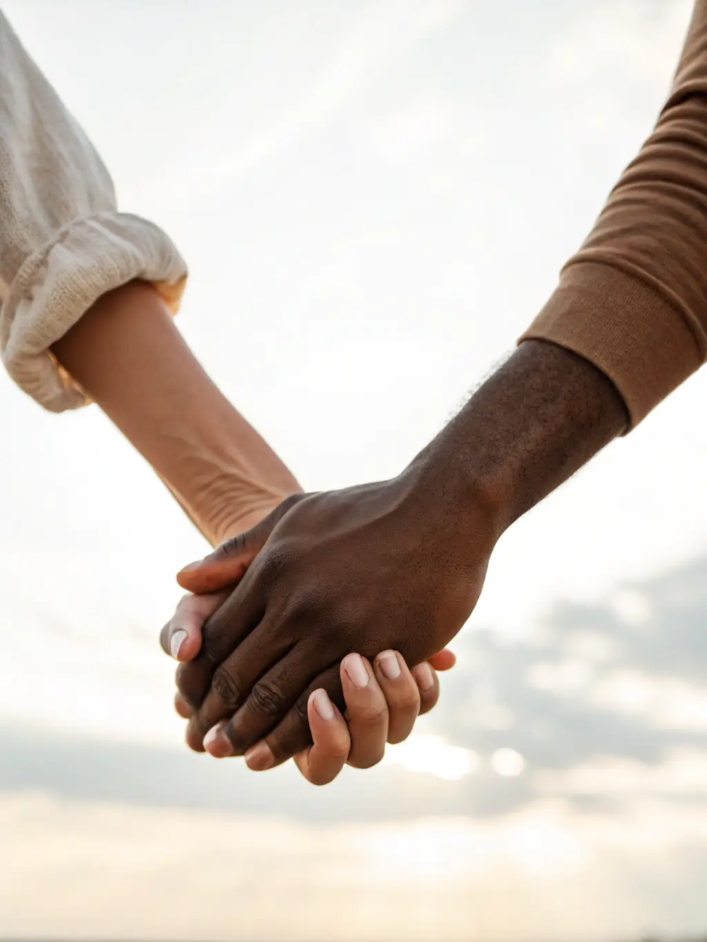 A close-up image of two hands gently intertwined, representing support and healing in relationships, with a warm, comforting color palette.